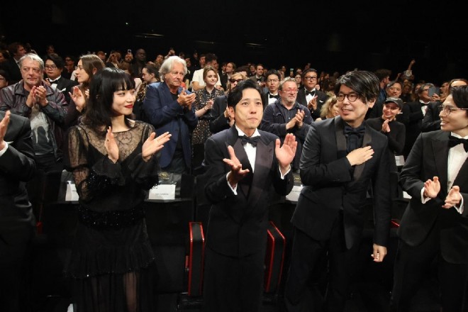 The Exit 8 team responds to a standing ovation at Cannes. From left: Nana Komatsu, Kazunari Ninomiya, director Genki Kawamura, and screenwriter Kentaro Hirase